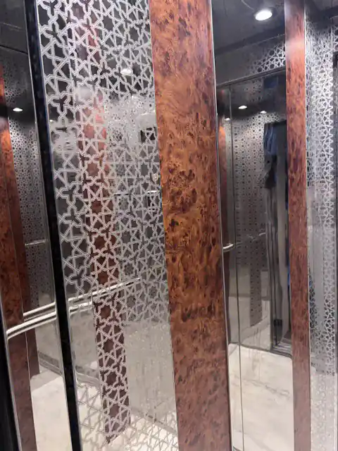 Cabin with cut-pattern steel and burl wood panels