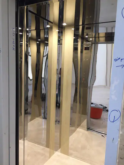 Cabin with gold mirror vertical strips, still under construction