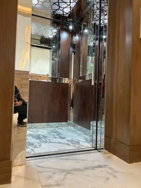 Glass-door cabin with wood walls and marble floor