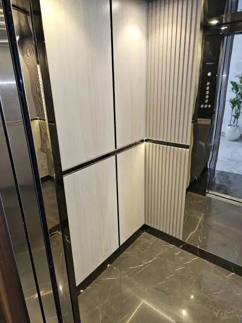 Cabin with cream fluted panel, marble floor and button panel