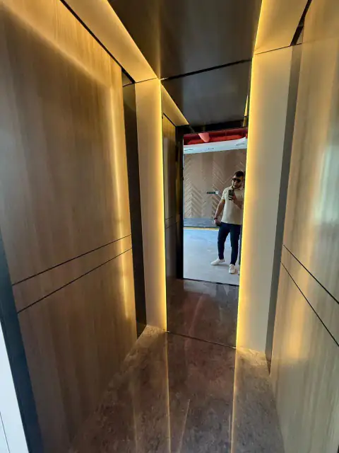 Narrow cabin with wood panels and amber LED edge lighting