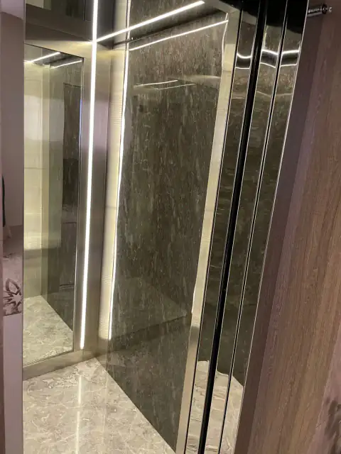 Cabin with grey marble wall panel, LED strips and glass door