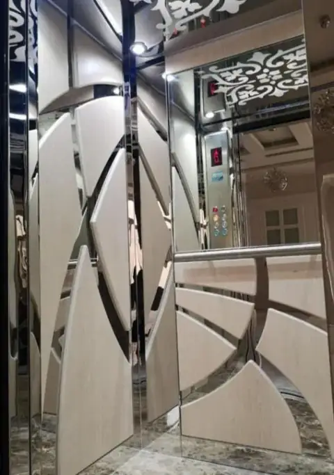 Cabin with curved mirror-steel and white panel design, button panel