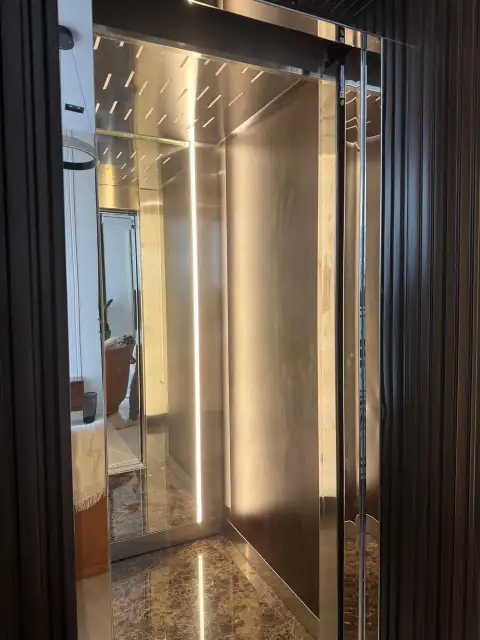 Cabin with LED strip lighting, wood panel and dark marble floor, door open