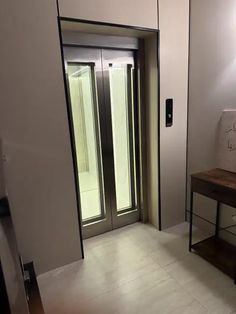 Glass double door lift in a home hall
