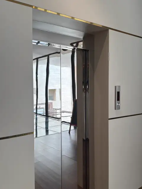 Landing door in a white wall beside a glass opening