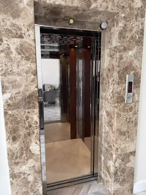 Marble-framed landing door with cabin visible