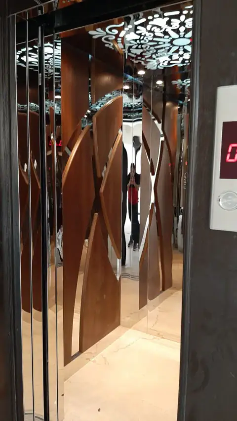 Wood and curved mirror cabin seen from the landing