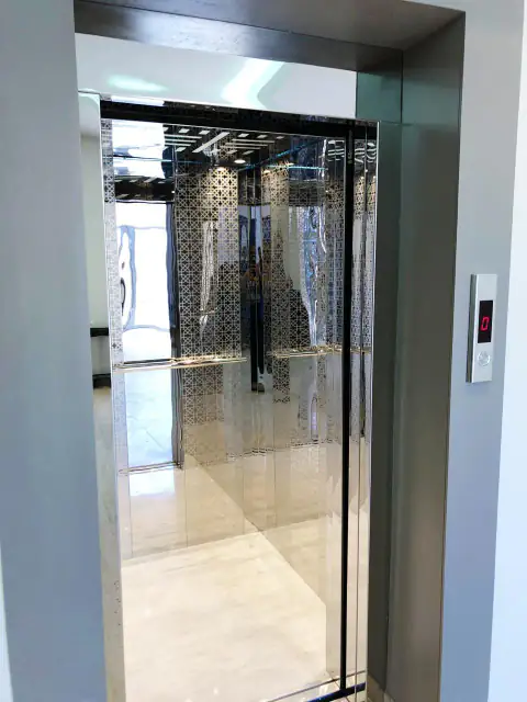 Etched-glass cabin seen from the landing, white wall