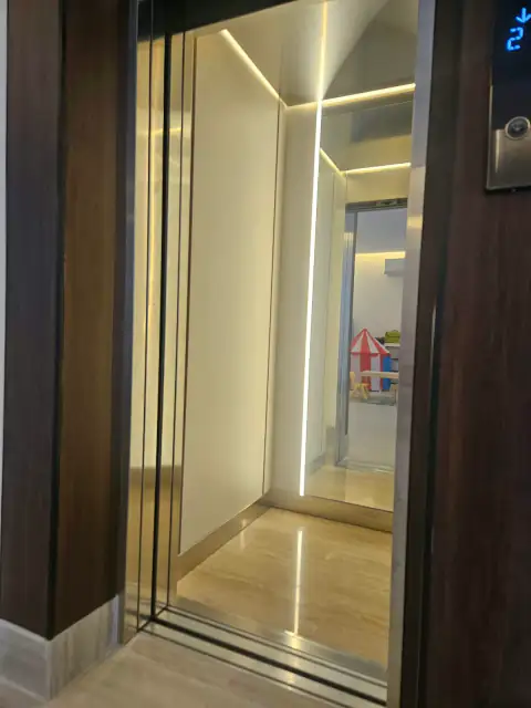Cabin with LED lighting seen from the landing, wood door frame