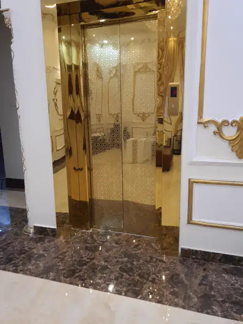 Gold mirror landing doors in a decorated hall