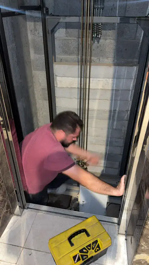 Technician fitting the cabin in a glass shaft