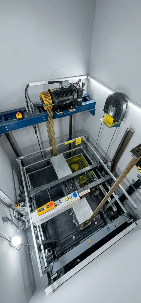 Top-down view of shaft with machine, ropes and car frame