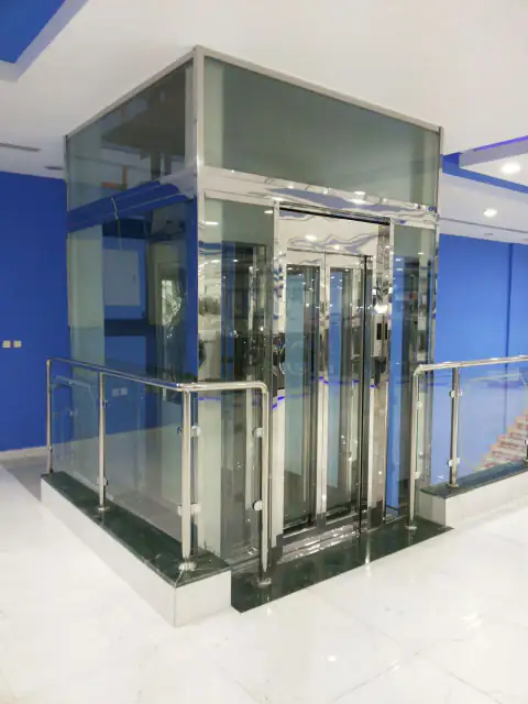 Panoramic glass lift with a stainless frame and a glass railing